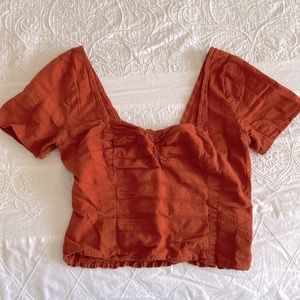 Pumpkin ruched crop top.